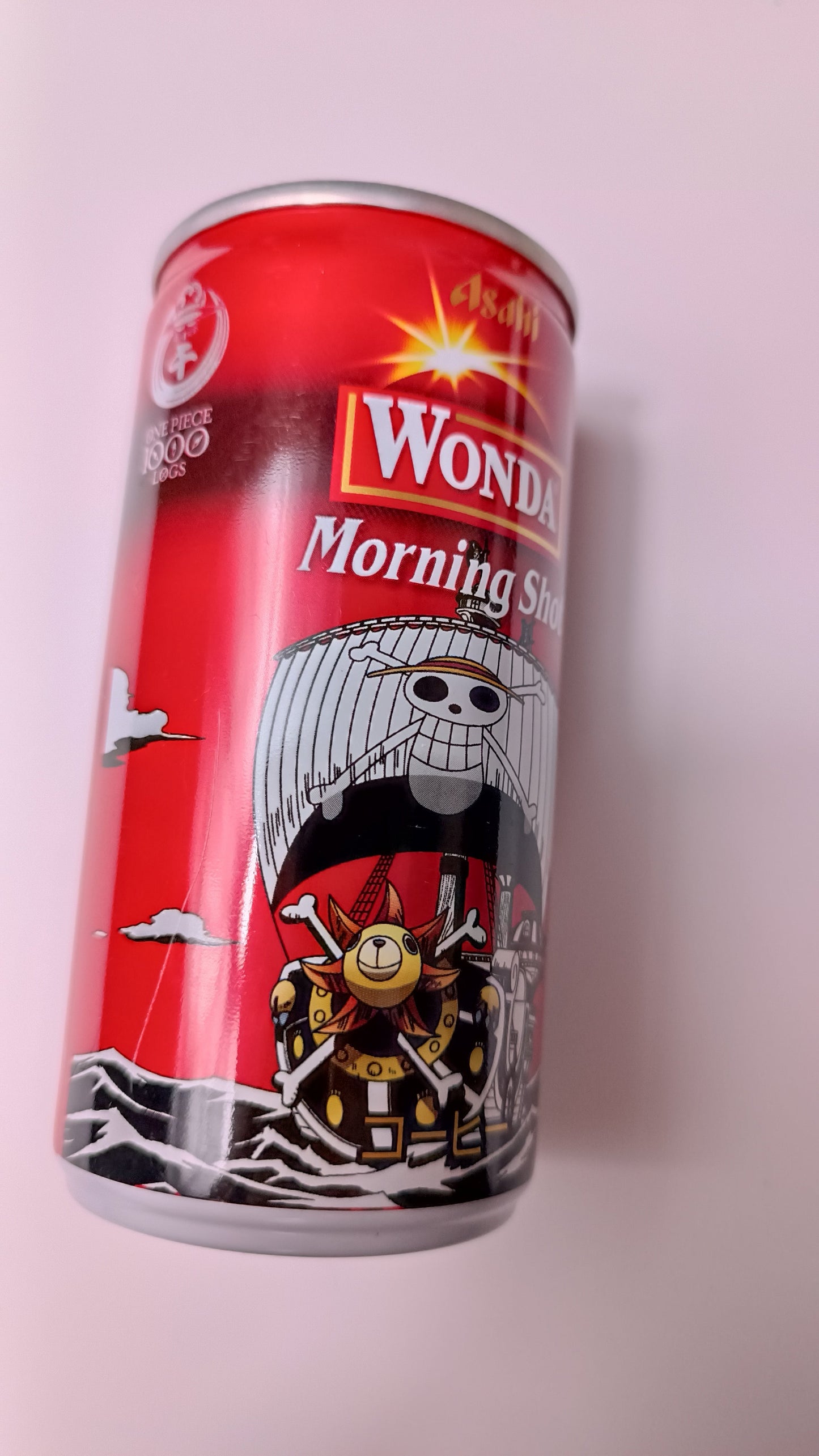 Red can with a graphic design on a light pink background
