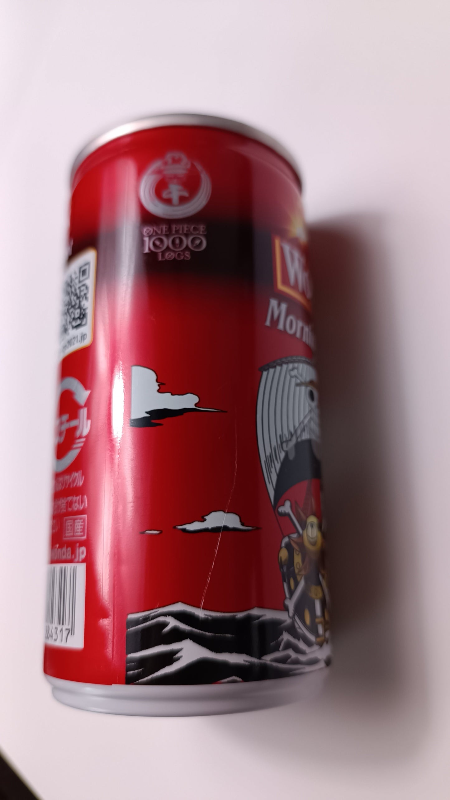 Red can with black and white graphics on a white background