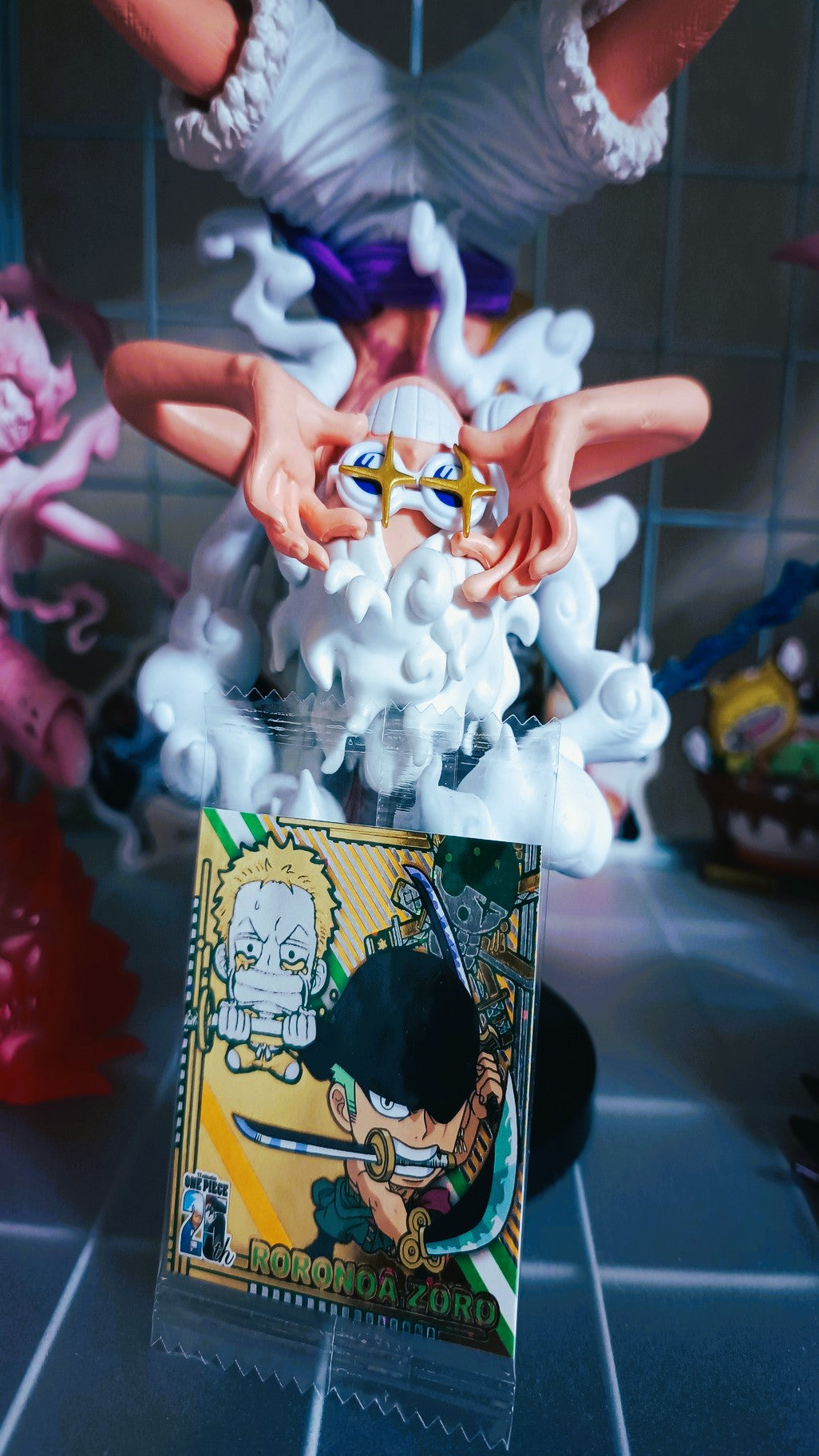 Figurine of a character with a card featuring another character on a tiled floor.