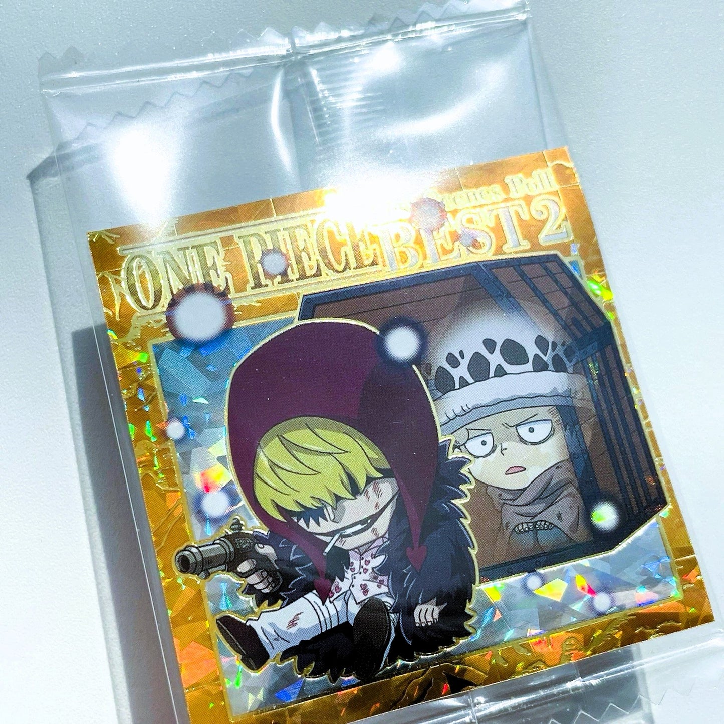 Card featuring characters from 'One Piece' in a clear packaging on a white background