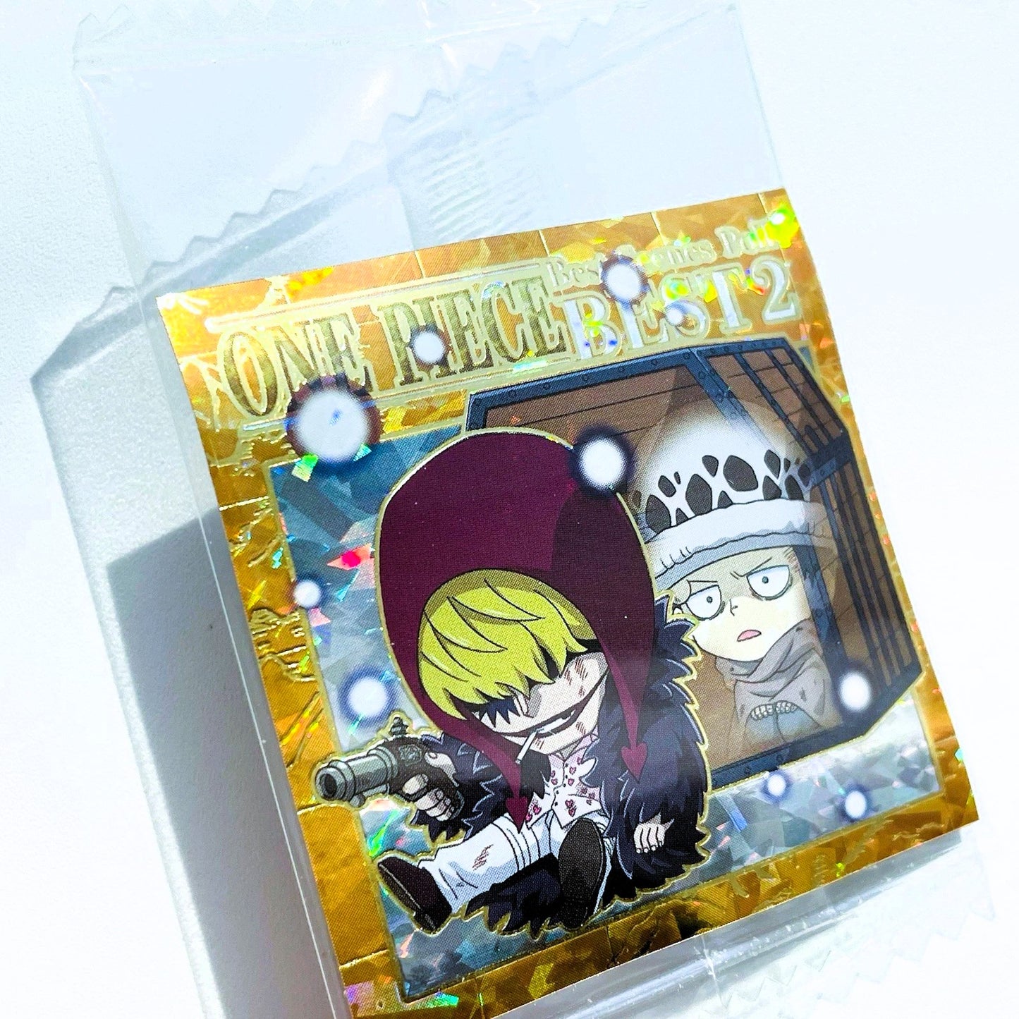 Card with anime-style illustration of a character with purple hair and another character in the background, enclosed in clear packaging.