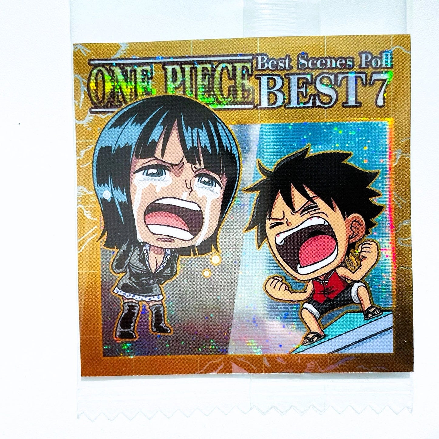 Packaging of 'One Piece Best Scenes Po BEST 7' with two animated characters on a gold background.