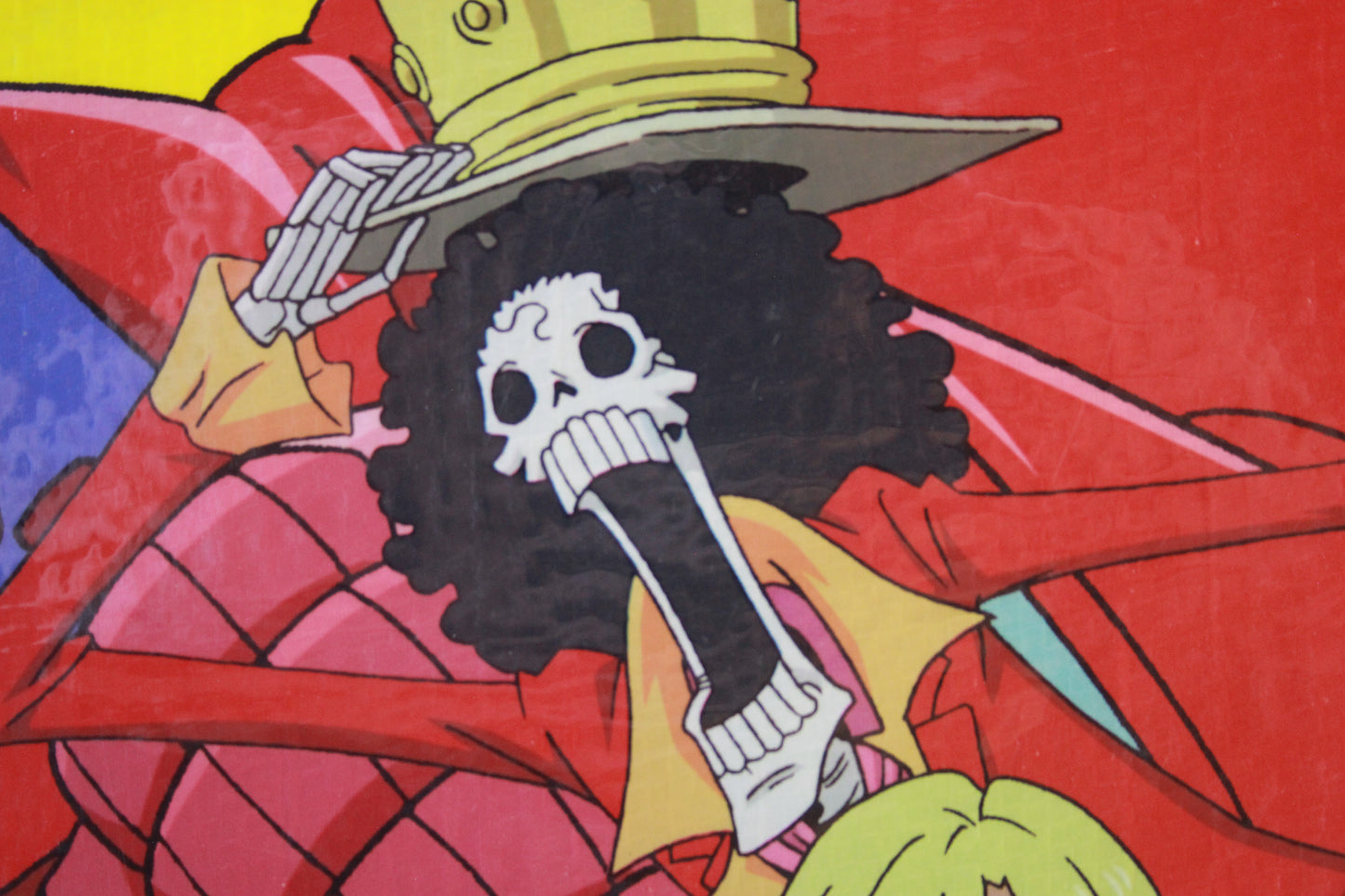Cartoon character with a large afro and skull design on a red background