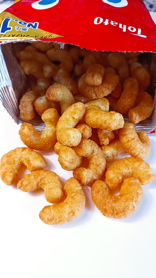 A bag of Tohato Caramel Corn with several pieces of caramelized popcorn displayed in front.