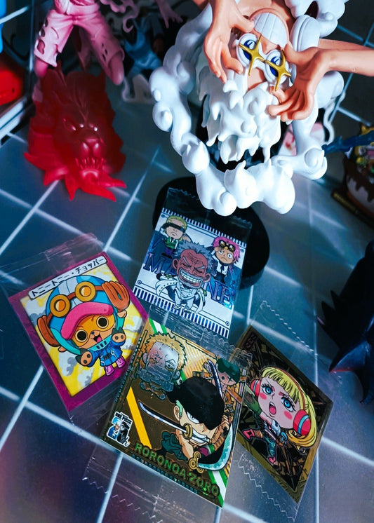 Colorful trading cards on a reflective surface with a toy figure in the background