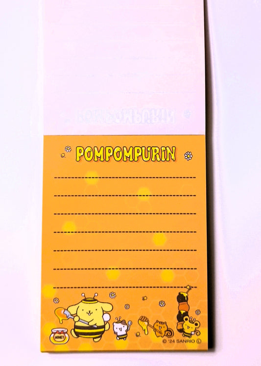 Notepad with Pompompurin character on a pink background